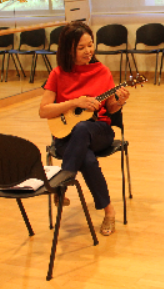 Helen practising on her ukulele for the Christmas party with CareNights