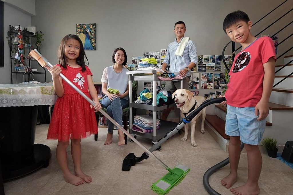 Mr Norman Ng and Ms Alice Wong got their kids, Lincoln and Paige (all above), to help tidy up and mop and vacuum the floor together with them. ST PHOTO: ALPHONSUS CHERN